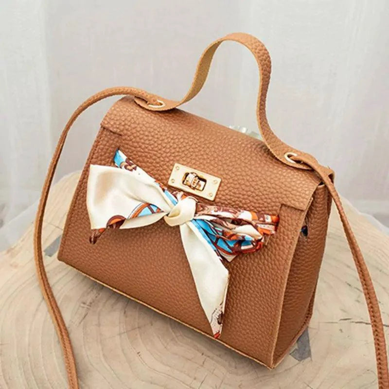 Elegant leather handbag and matching scarf by MANDOTOS, featuring stylish design and high-quality craftsmanship.