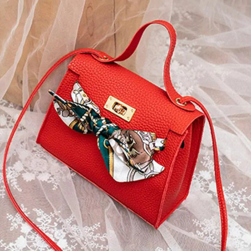 Elegant leather handbag and matching scarf from MANDOTOS, featuring sophisticated design and craftsmanship.