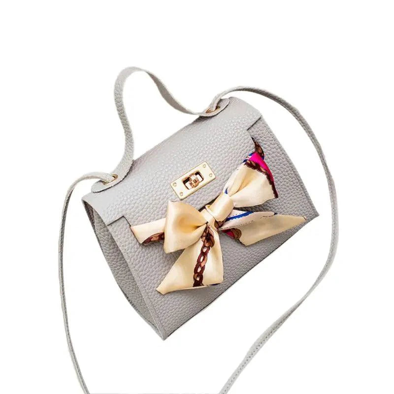 Elegant leather handbag and matching scarf by MANDOTOS, featuring stylish design and high-quality materials.