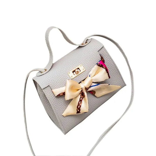 Elegant leather handbag and matching scarf by MANDOTOS, featuring stylish design and high-quality materials.