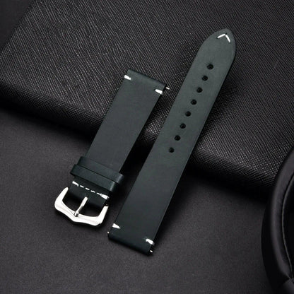 Elegant leather watch band by MANDOTOS, showing a close-up of the sleek, brown strap with stitching detail and polished metal buckle.