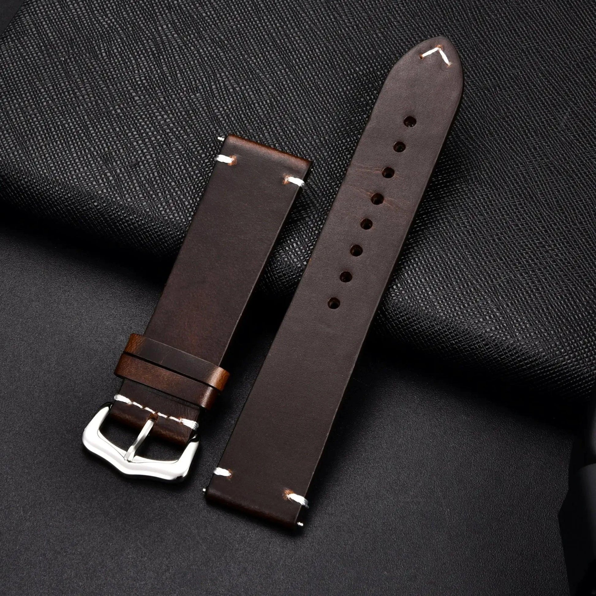 Elegant leather watch band by MANDOTOS, showcasing a smooth, stylish strap with metal buckle for a refined accessory.