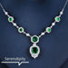 Mandotos Emerald Elegance white gold necklace featuring a central emerald gemstone and delicate chain design.