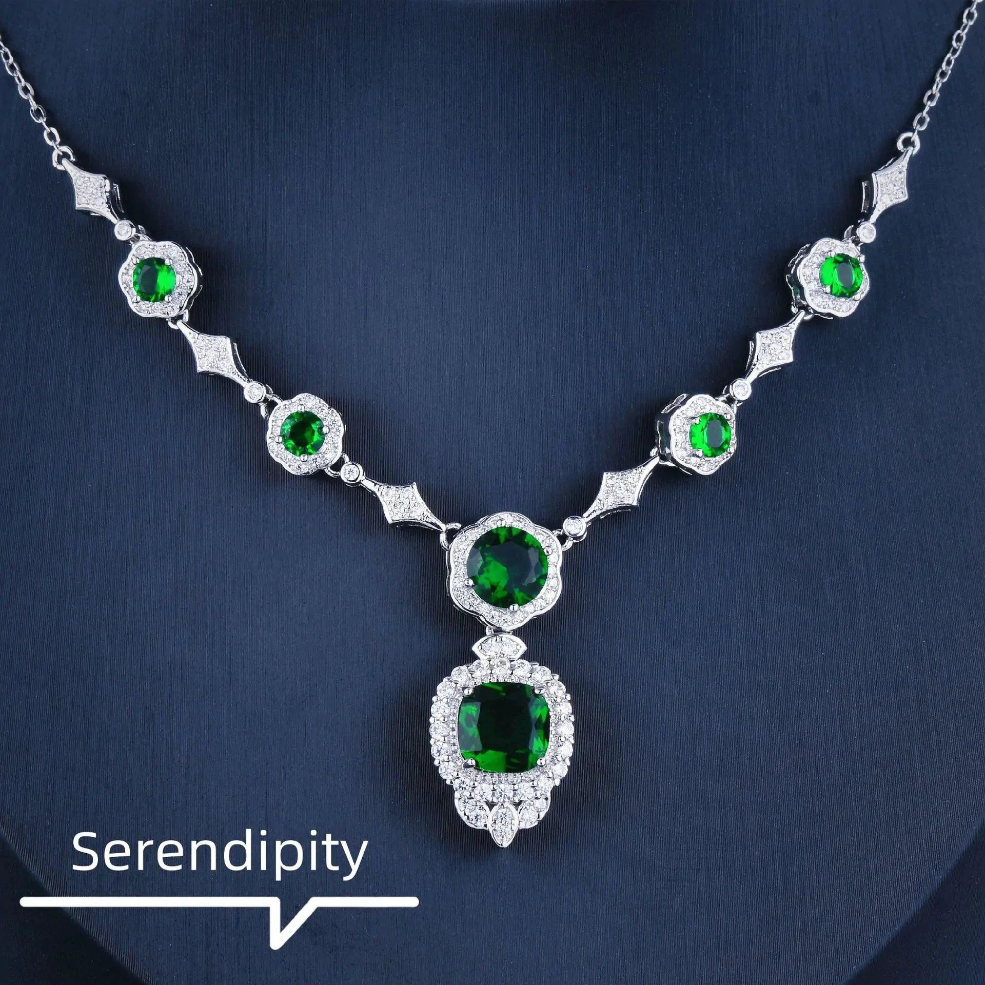 Mandotos Emerald Elegance white gold necklace featuring a central emerald gemstone and delicate chain for sophisticated style.