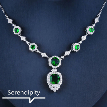 Mandotos Emerald Elegance white gold necklace featuring a central emerald gemstone and delicate chain for sophisticated style.