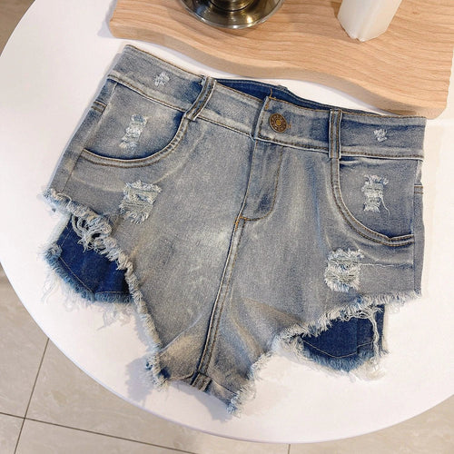 Light-colored high waist raw hem jeans by MANDOTOS, European chic style, showcasing fitted silhouette and raw hem detail.
