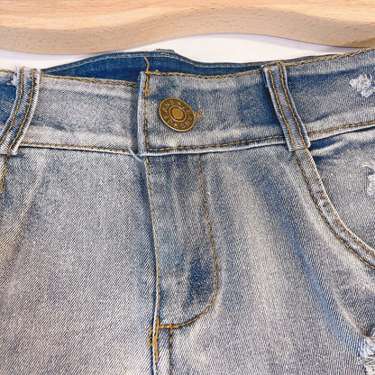 Light-colored high waist raw hem jeans by MANDOTOS, European chic style, showcasing distressed raw edges and classic denim fit.