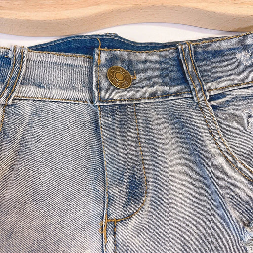 Light-colored high waist raw hem jeans by MANDOTOS, European chic style, showcasing distressed raw edges and classic denim fit.