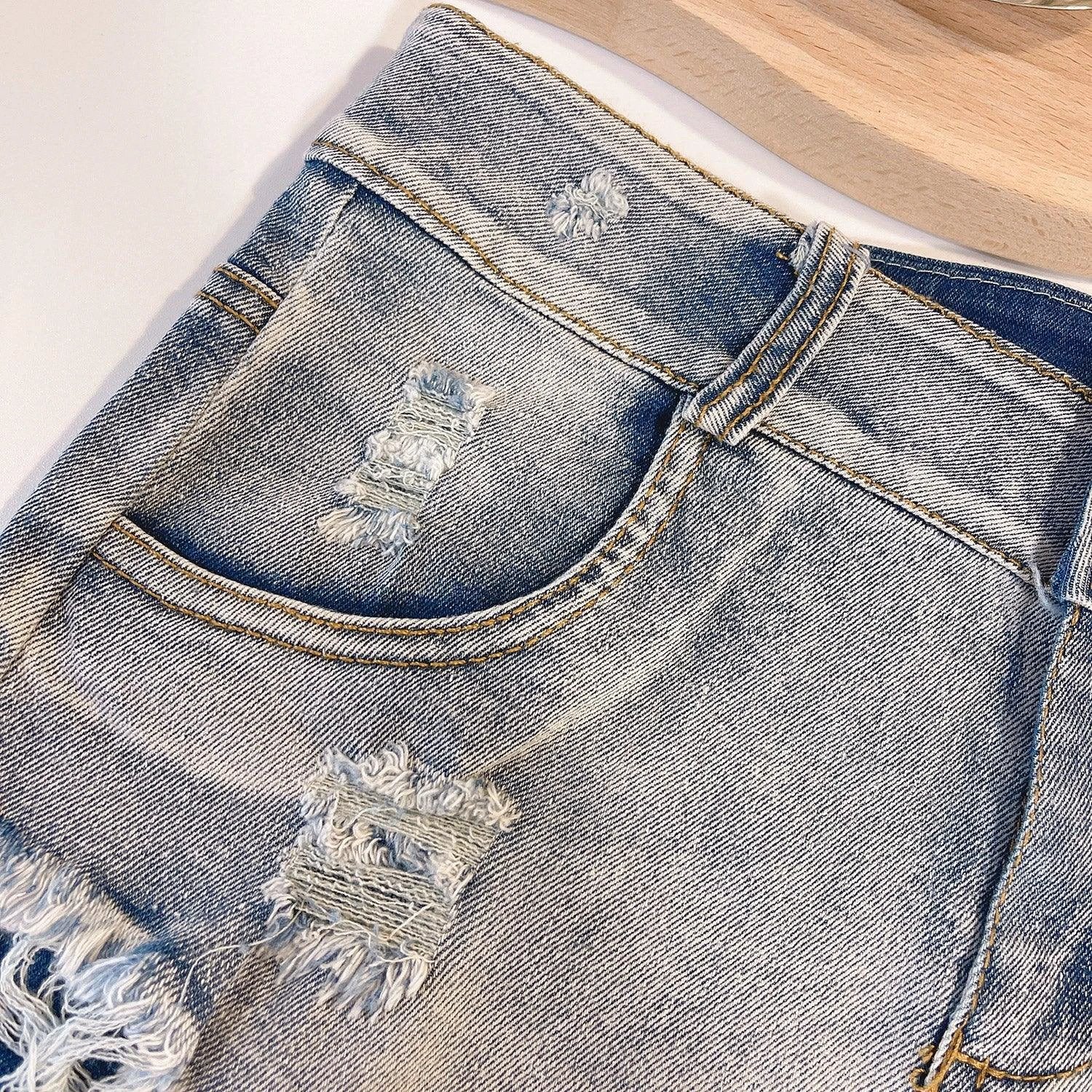 European Chic high waist raw hem jeans by MANDOTOS, light-colored denim with a stylish raw hem and classic fit.