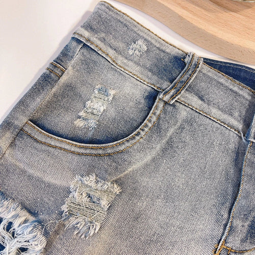 European Chic high waist raw hem jeans by MANDOTOS, light-colored denim with a stylish raw hem and classic fit.