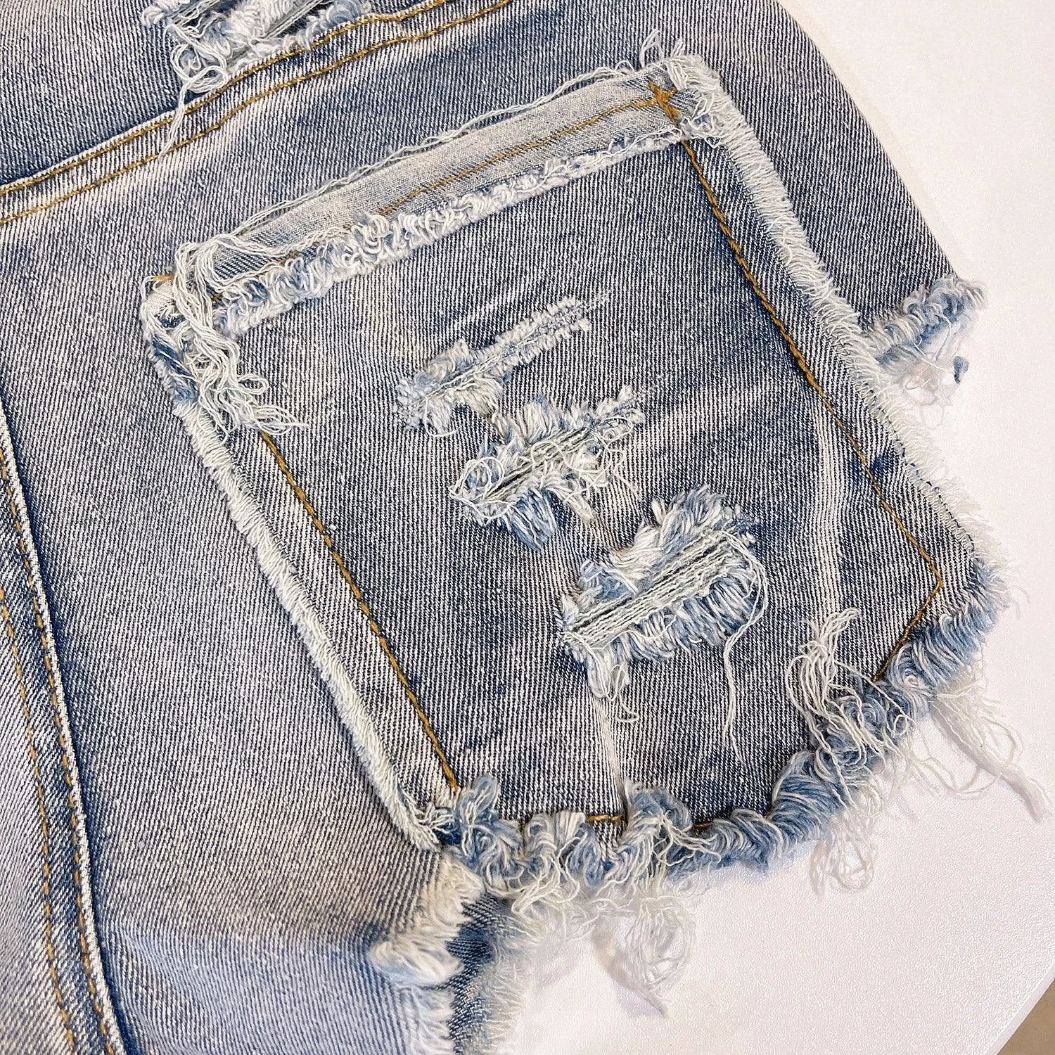 Light-colored raw hem high waist jeans by MANDOTOS, European chic style, shown on a model with casual styling.