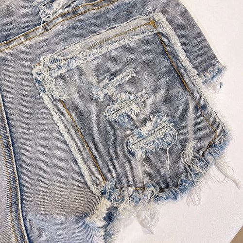 Light-colored raw hem high waist jeans by MANDOTOS, European chic style, shown on a model with casual styling.