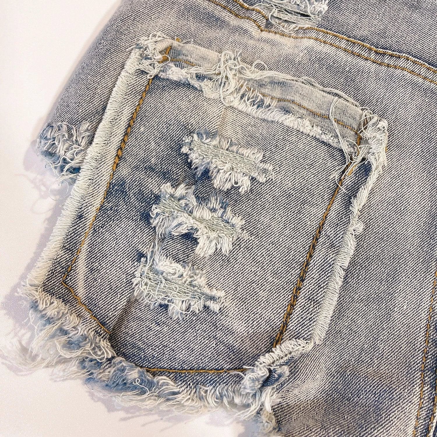 Light-colored high waist raw hem jeans by MANDOTOS featuring a European chic style and classic denim look.