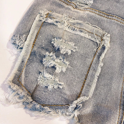 Light-colored high waist raw hem jeans by MANDOTOS featuring a European chic style and classic denim look.