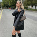 Mandotos Farah faux leather blazer featuring a tailored fit, classic lapels, and sleek black finish for a stylish, modern look.