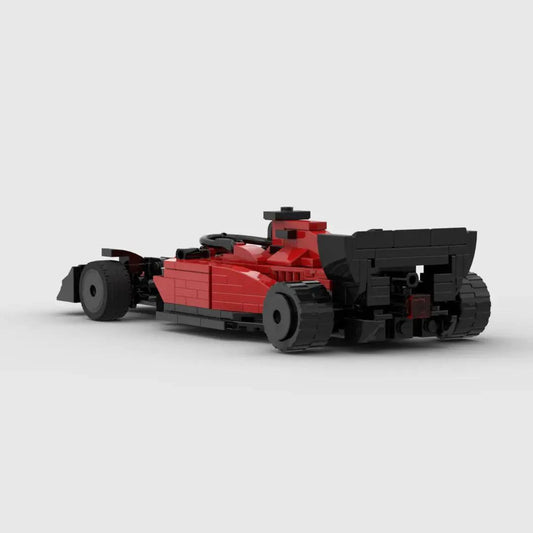 Small red Ferrari F1 racing toy car by MANDOTOS with detailed design and racing decals, suitable for children and collectors.