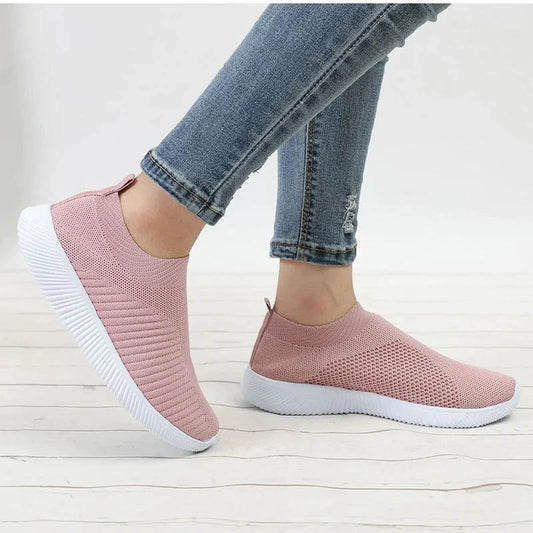 Mandotos flat knitted shoes in neutral tones, showcasing their comfortable and stylish slip-on design.