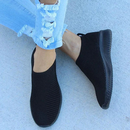 Mandotos flat knitted shoes in neutral tones, showcasing their comfortable, stylish design and soft textured knit upper.