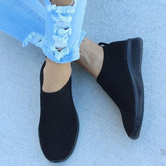 Mandotos flat knitted shoes in neutral tones, showcasing their comfortable, stylish design and soft textured knit upper.