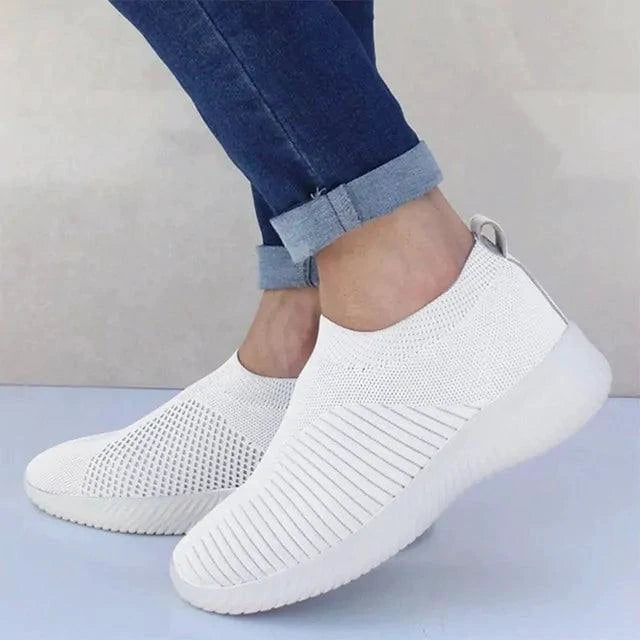 Mandotos flat knitted shoes in beige with slip-on design, showcasing their comfortable and stylish footwear look.