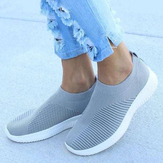 Mandotos flat knitted shoes in neutral tones with a sleek, minimalist design and breathable knit upper.