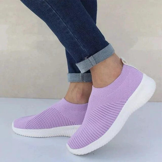 Mandotos flat knitted shoes in neutral tones, showcasing a comfortable, stylish design with a textured knit upper.