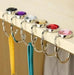 Mandotos foldable metal purse hook, portable handbag hanger with compact design for holding bags on tables or counters.