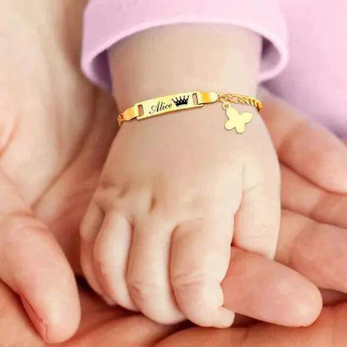 Gold butterfly charm bracelet for kids by MANDOTOS, featuring a delicate butterfly pendant on a sleek gold chain.