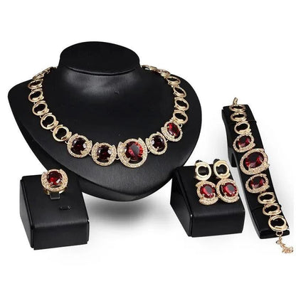 Mandotos 4-piece gold jewelry set with blue gemstones, perfect for wedding collection featuring necklace, earrings, bracelet, and ring