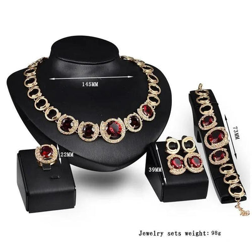 Mandotos gold jewelry set with four pieces featuring blue gems, perfect for wedding or special occasions.