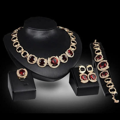 Mandotos 4-piece gold jewelry set with blue gems, perfect for wedding collection featuring necklaces, earrings, and bracelet.