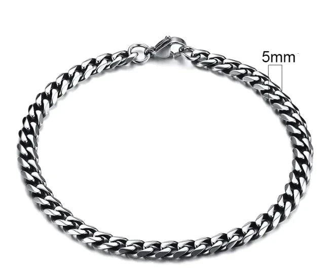 Gold-tone stainless steel Cuban bracelet by MANDOTOS, 3-11mm wide, featuring classic interlocking links on a sleek design.
