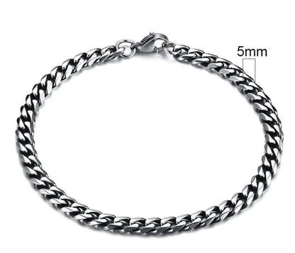 Gold-tone stainless steel Cuban bracelet by MANDOTOS, 3-11mm wide, featuring classic interlocking links on a sleek design.