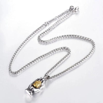 Golden Buddha pendant from MANDOTOS featuring intricate design and polished gold finish, hanging on a delicate chain.
