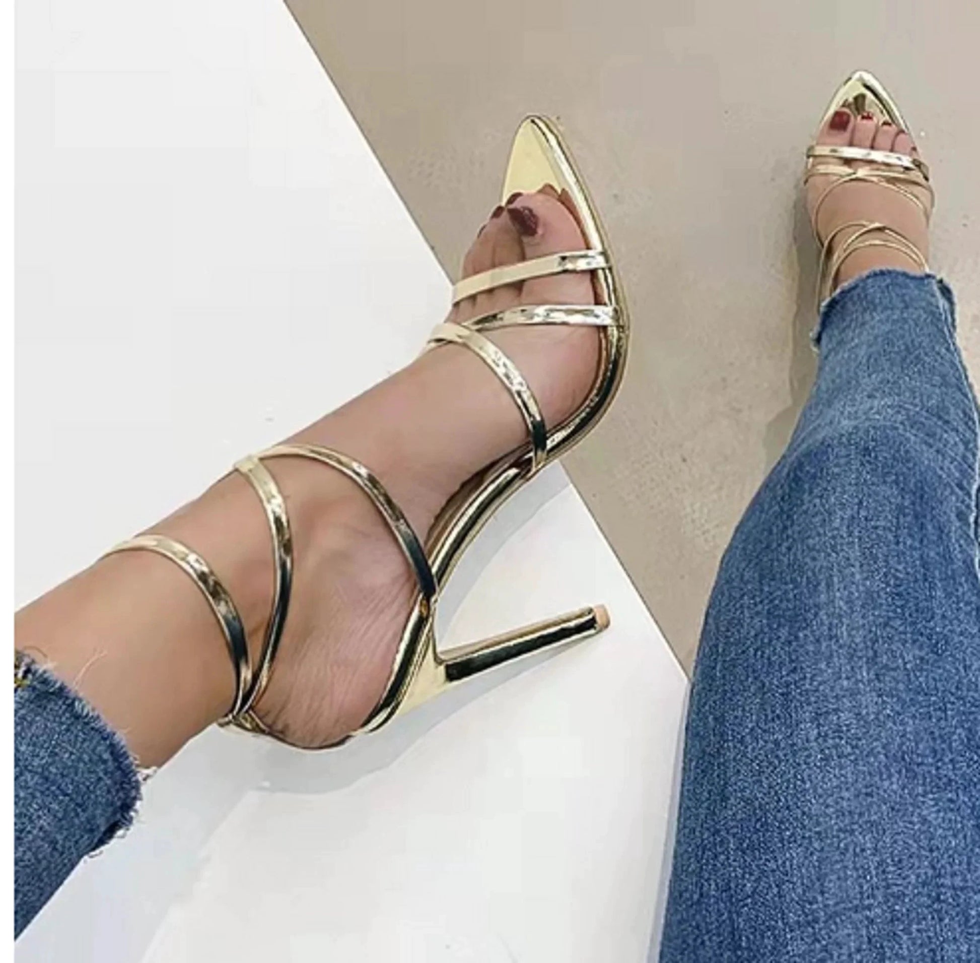 Golden strappy stiletto pumps by MANDOTOS with high heels and elegant design, perfect for formal or evening wear.