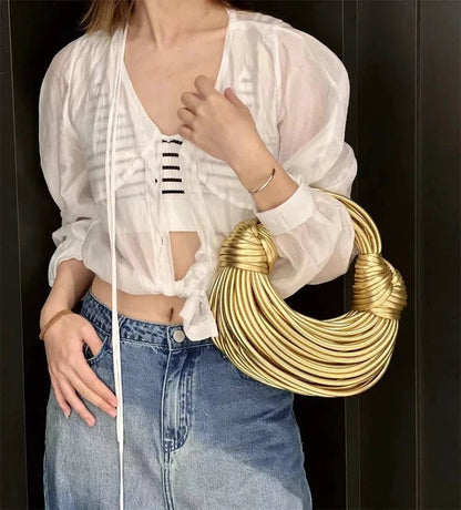 Mandotos women's luxury gold handbag with handwoven noodle design, rope knot accents, hobo style, silver evening clutch.
