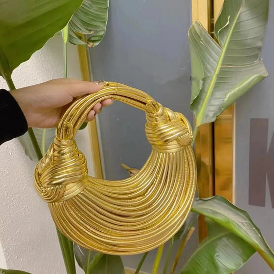 Mandotos gold luxury designer women's handbag with handwoven noodle design, rope knot details, hobo and evening clutch style.