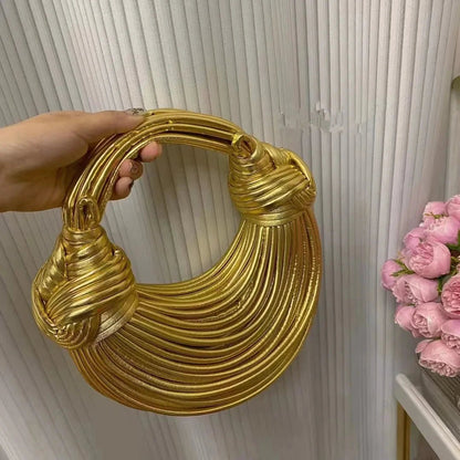 Mandotos women's luxury gold and silver designer handbag featuring handwoven noodle design, rope knots, and evening clutch style.