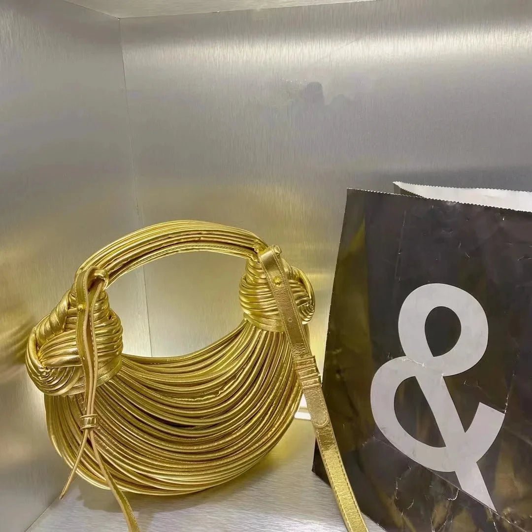 Mandotos gold luxury designer handbag for women, woven noodle design with rope knots, silver evening clutch, stylish and elegant.