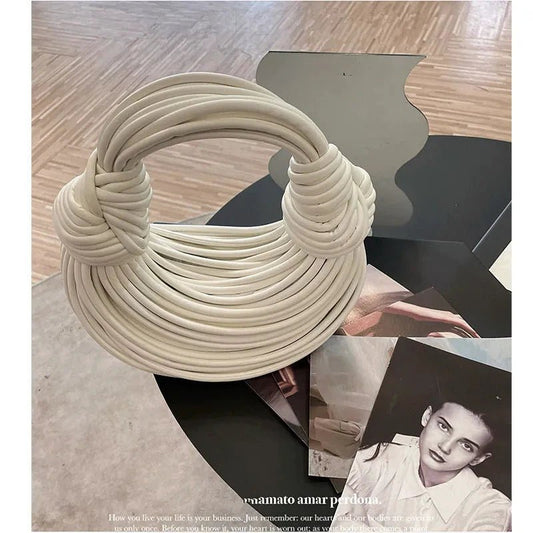 Mandotos luxury women's handbag, gold and silver evening clutch with handwoven noodle design, rope knots, and hobo style.