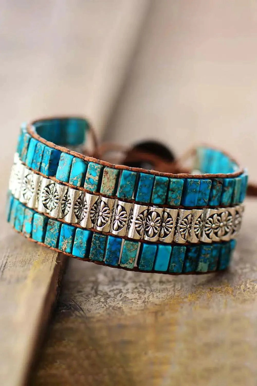 Handmade triple-layer natural stone bracelet by MANDOTOS featuring polished stones and adjustable cord.