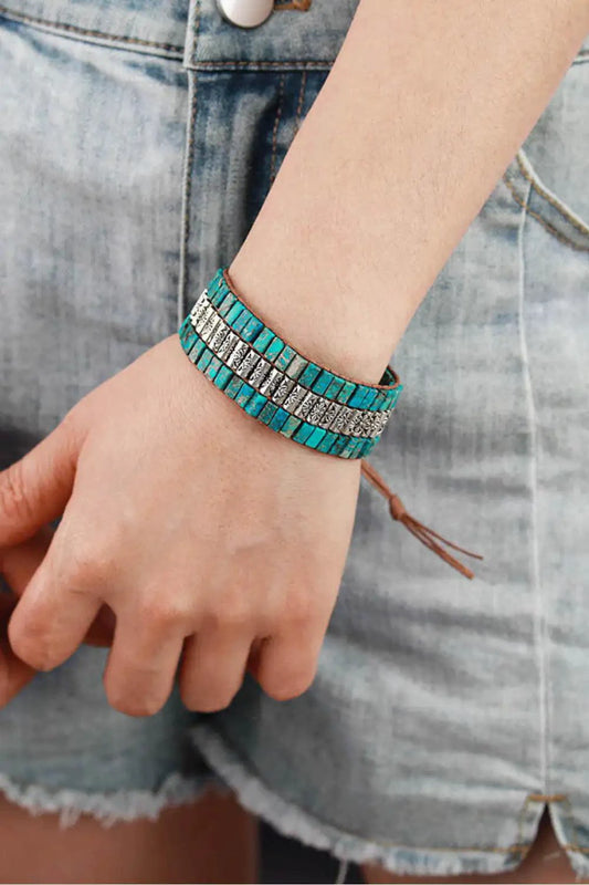 Handmade triple-layer natural stone bracelet from MANDOTOS featuring smooth, polished stones in earthy tones.