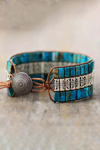 Handmade triple-layer natural stone bracelet by MANDOTOS featuring smooth, round stones in earthy tones and adjustable cord.