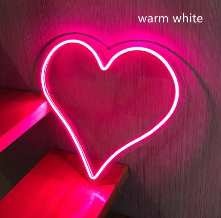 Mandotos Heart Glow LED neon light illuminated in pink, perfect for room decor and adding a vibrant glow to spaces.