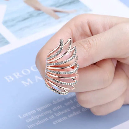 Mandotos Heavenly Diamond Wing Ring featuring sparkling diamonds and intricate wing design in silver tone craftsmanship.