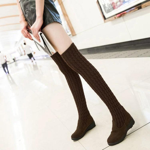 Black high flat over-the-knee stretch Martin boots by MANDOTOS, with sleek design and knee-high length visible.