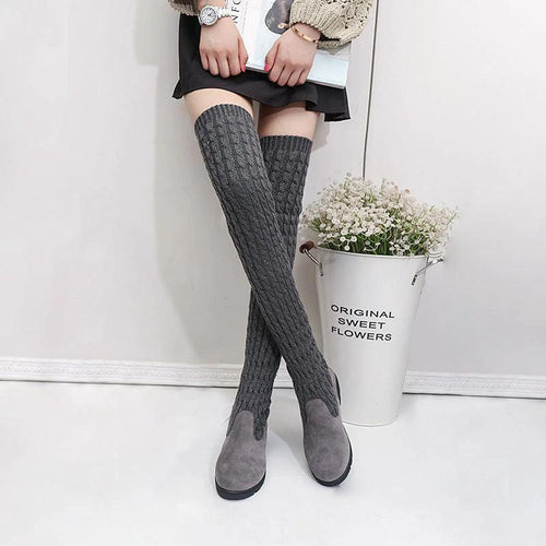 High flat over-the-knee stretch Martin boots by MANDOTOS, featuring sleek black design and knee-high length.