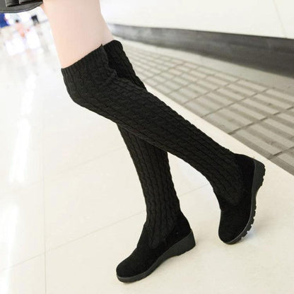 Close-up of black high flat over-the-knee stretch Martin boots by MANDOTOS, showcasing sleek design and smooth leather finish.