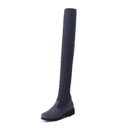 Mandotos high flat over-the-knee stretch Martin boots showcasing sleek black leather and knee-high design.