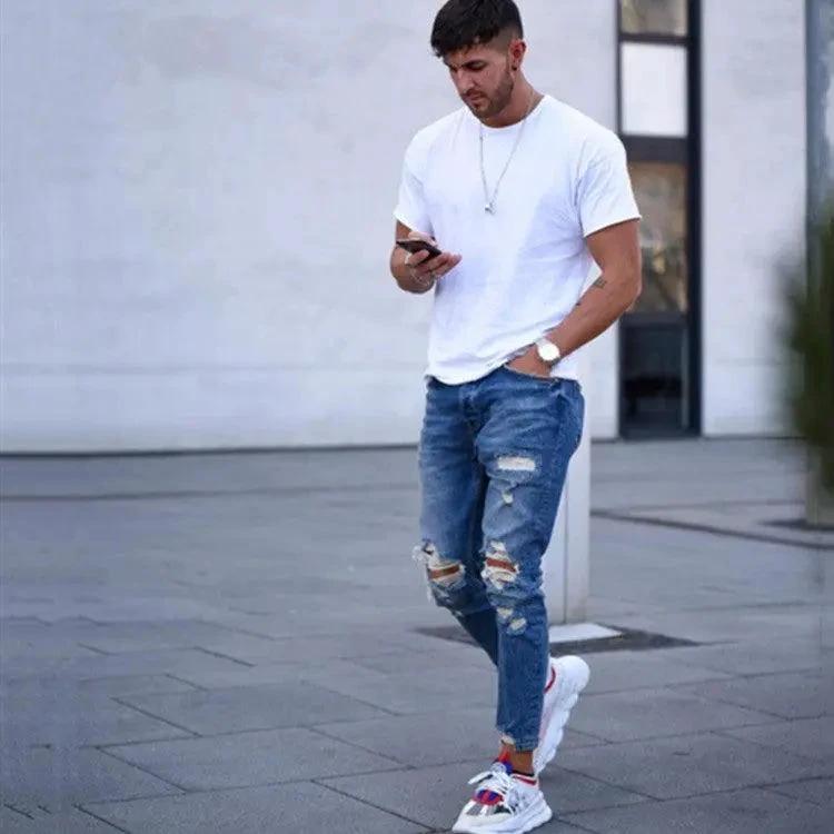 Mandotos men's jeans with stylish holes, classic fit and denim texture, displayed on a plain background.